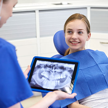 dentist holding girls x-rays