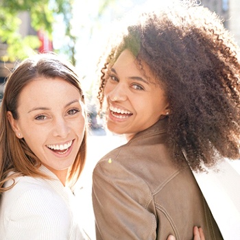 Friends smiling while shopping together