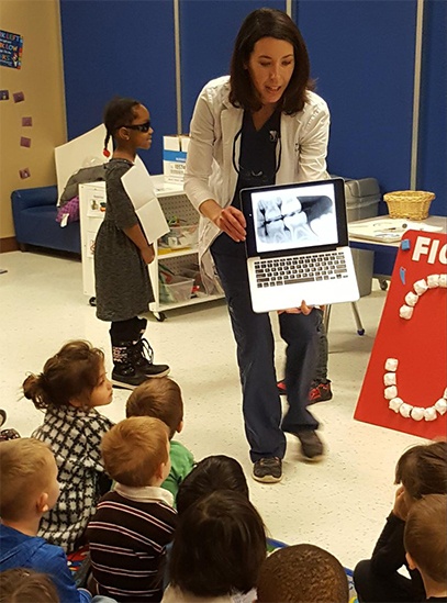 dentist showing x-ray to kids