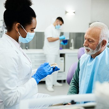 Dentist discussing replacement teeth with patient