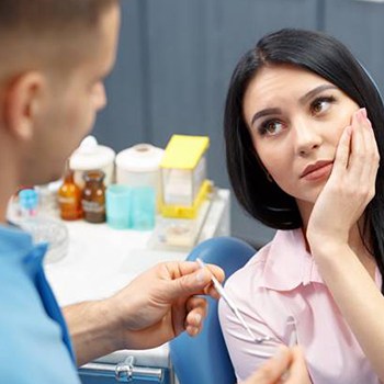 Woman holding jaw in pain