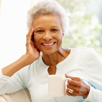 woman holding coffee cup smiling
