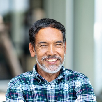 man in plaid shirt smiling
