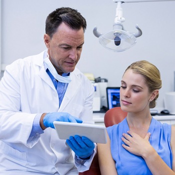 dentist showing woman tablet