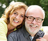 husband and wife smiling at camera