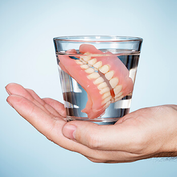 dentures in glass of water