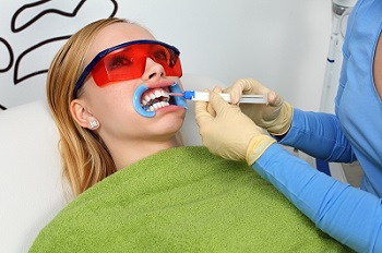 Woman receiving in-office teeth whitening