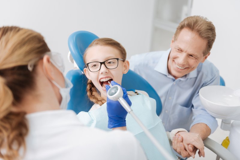 a dad and daughter at the dentist office