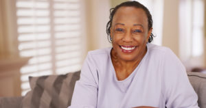 Smiling woman with dental implants in Crown Point