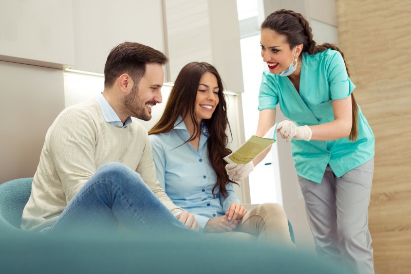 Dentist talking to patients about dental membership plan