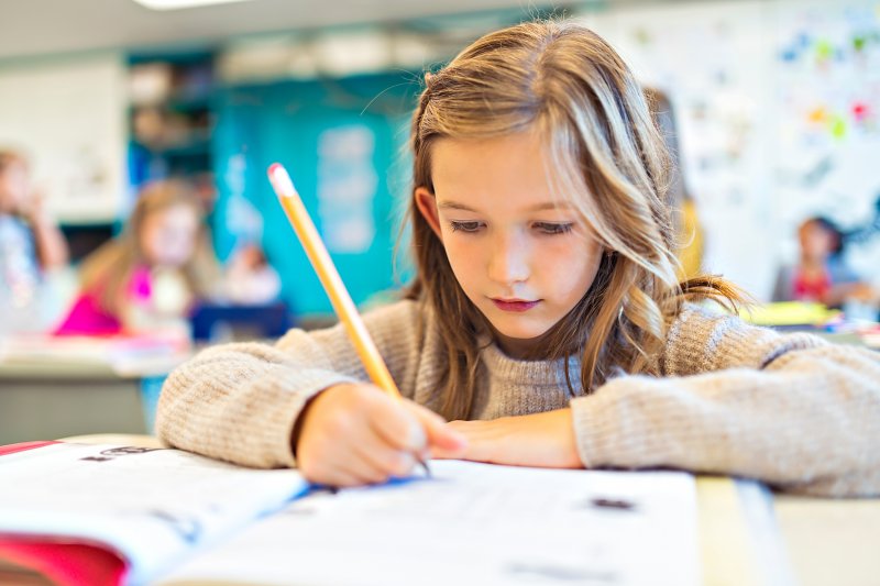 Child studying after visiting her dentist in Crown Point