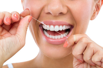 person spring cleaning smile by flossing teeth 