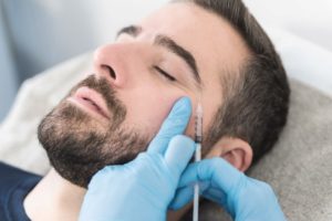 Man receiving BOTOX injection close to his eye